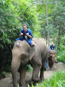 Colt & I treking elephants through the jungle in Thailand 